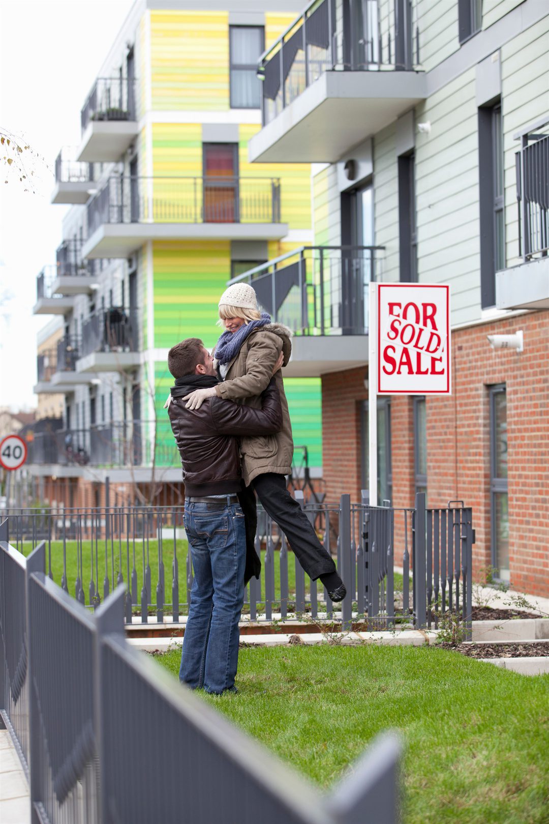 couple-celebrating-in-front-of-apartment