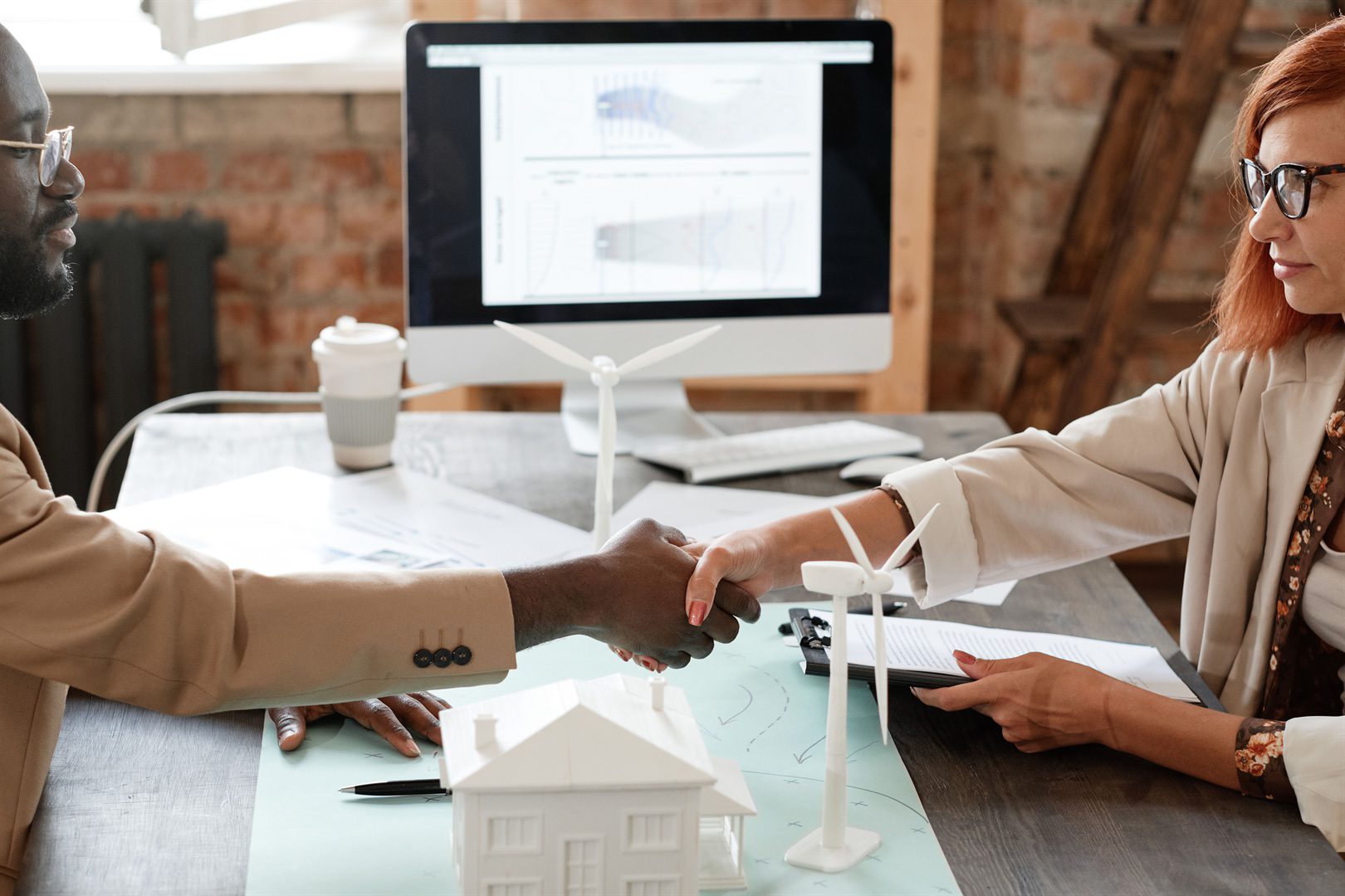 business-partners-shaking-hands-at-meeting