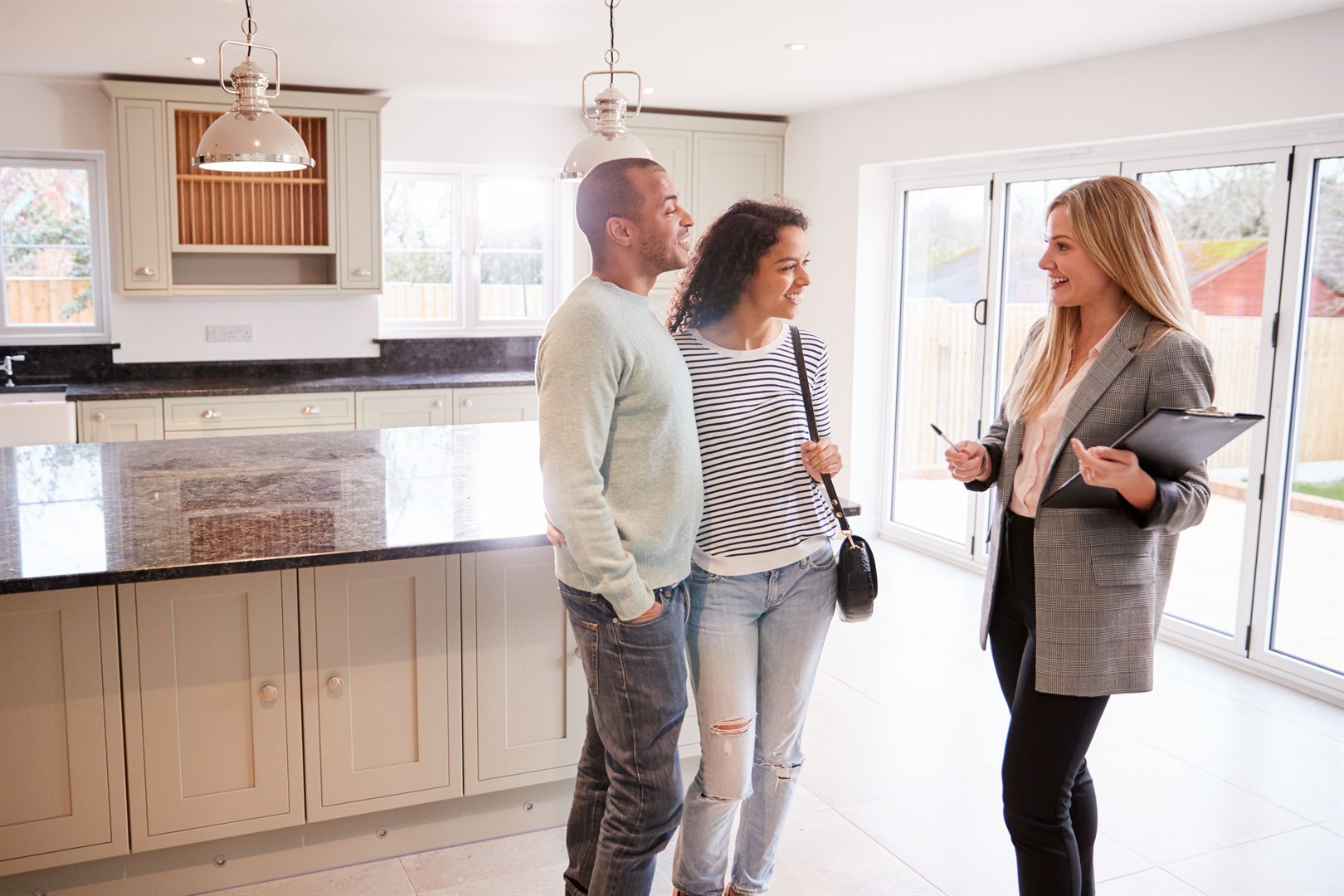 female-realtor-showing-couple-interested-in-buying