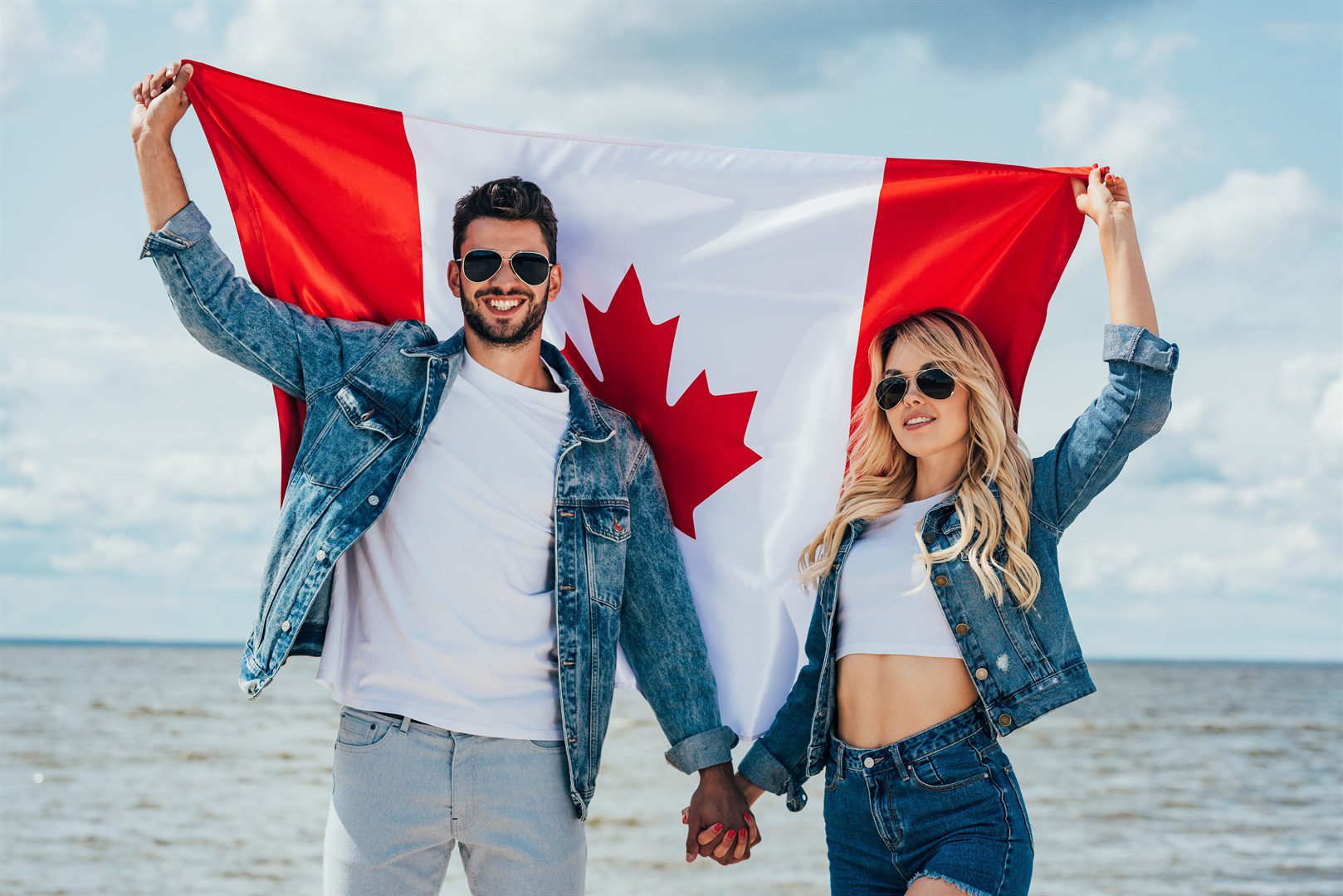 blonde-woman-and-man-in-jacket-holding-canadian-flag